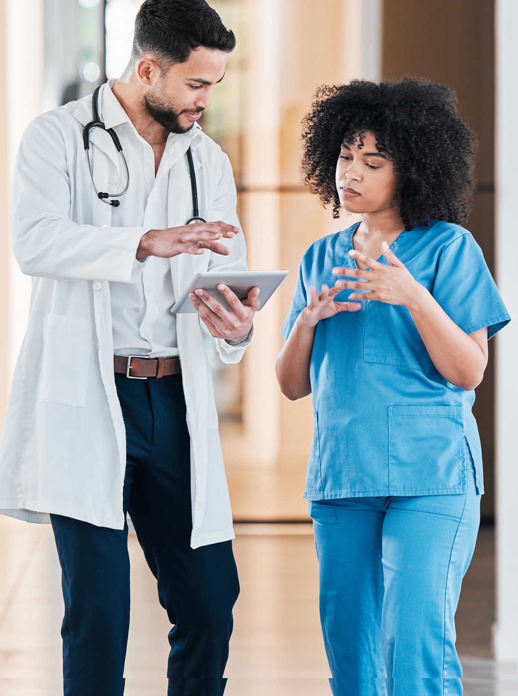 Clinicians reviewing patient data on a tablet